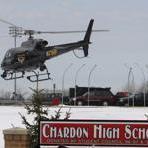 An Ohio State Highway patrol helicopter leaves Chardon High School Monday, Feb. 27, 2012, in Chardon, Ohio. A gunman opened fire inside the high schools cafeteria at the start of the school day Monday, wounding five students, according to officials and local hospitals. A suspect is in custody. (AP Photo/Tony Dejak)
